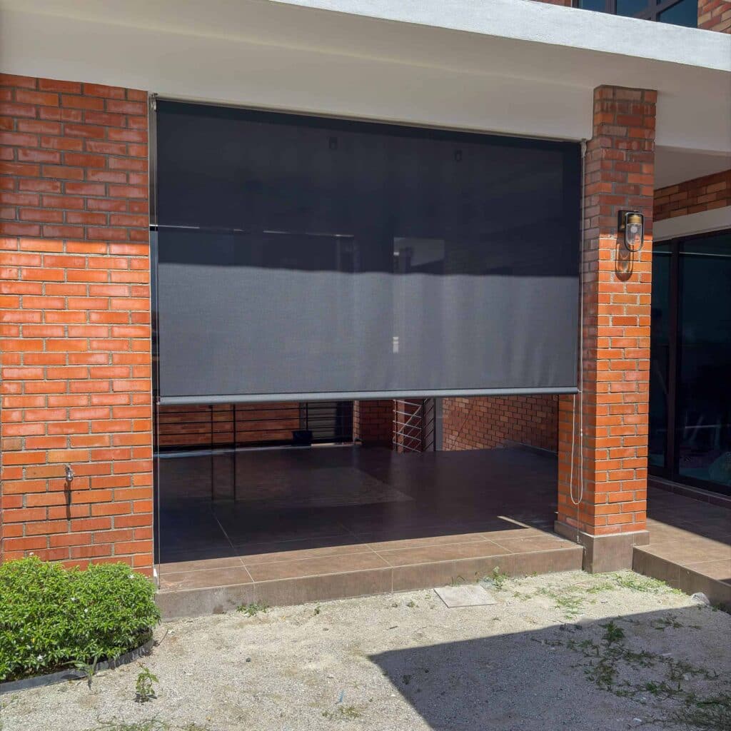 A heavy duty outdoor blind on a brick patio